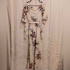 Floral cream colored romper with tie waist. Worn to a wedding. Split legs